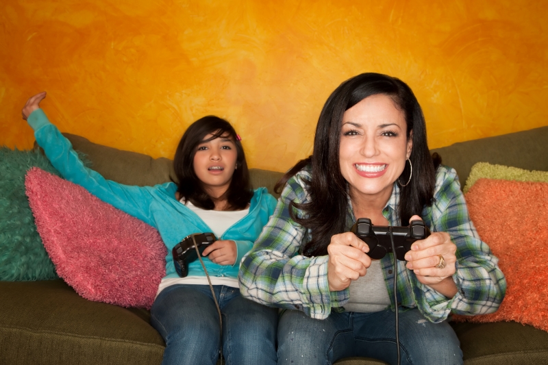 1150417-hispanic-woman-and-girl-playing-video-game